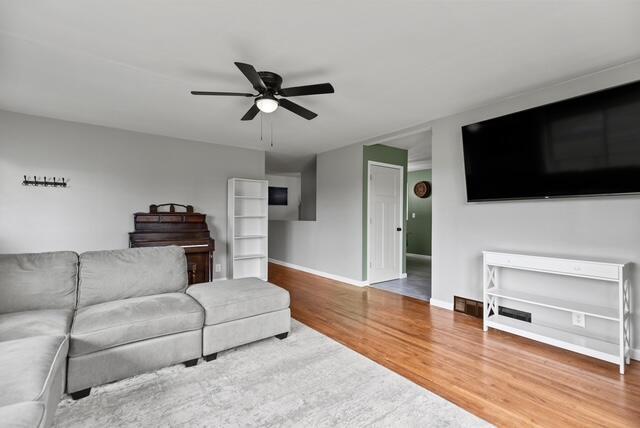 507 E 4th St, Hersey, MI 49639 - living area with ceiling fan, wood finished floors, and baseboards