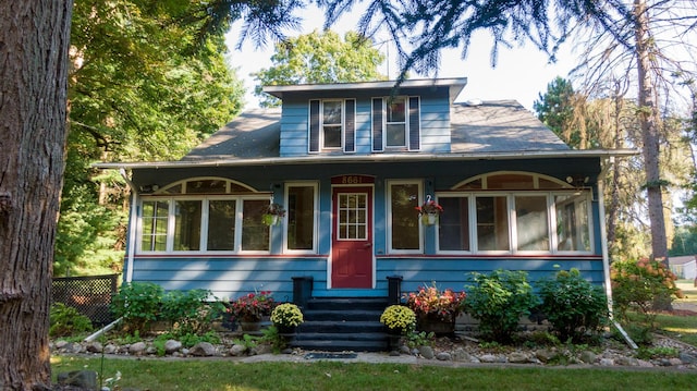 8661 Elm Valley Rd, Union Pier, MI 49129 - view of front of house with a sunroom and entry steps