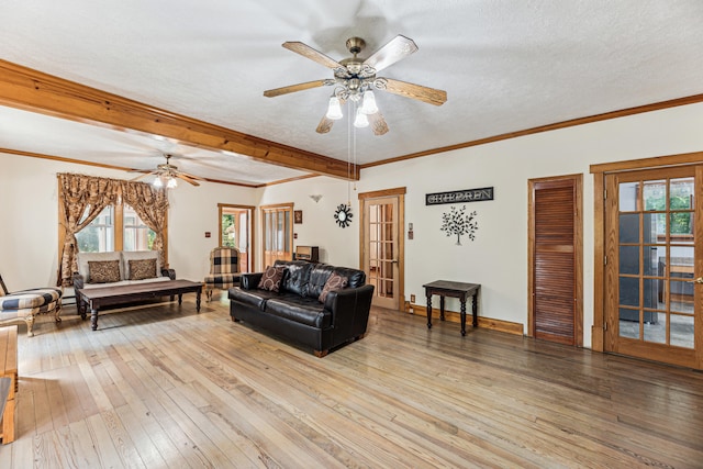 8661 Elm Valley Rd, Union Pier, MI 49129 - living area featuring light wood-type flooring, healthy amount of natural light, ceiling fan, a textured ceiling, and beam ceiling