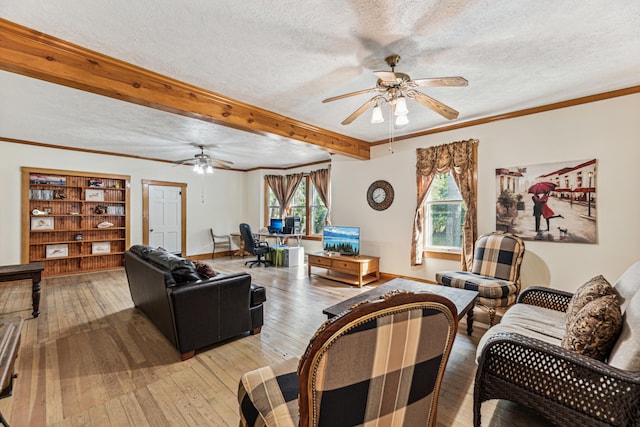 8661 Elm Valley Rd, Union Pier, MI 49129 - living room featuring a ceiling fan, a textured ceiling, light wood finished floors, healthy amount of natural light, and beam ceiling