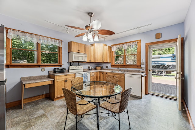 8661 Elm Valley Rd, Union Pier, MI 49129 - kitchen featuring white appliances, track lighting, a sink, a ceiling fan, and light countertops