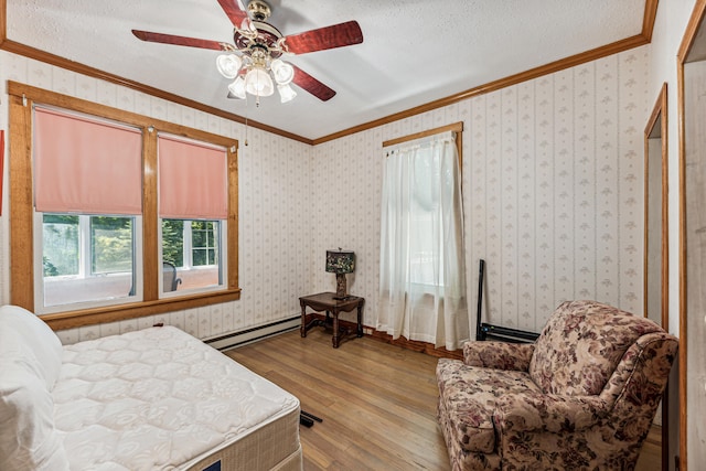8661 Elm Valley Rd, Union Pier, MI 49129 - bedroom featuring hardwood / wood-style flooring, baseboard heating, ornamental molding, a textured ceiling, and a ceiling fan