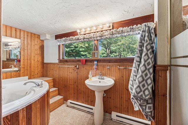 8661 Elm Valley Rd, Union Pier, MI 49129 - bathroom featuring a baseboard radiator, wood walls, and a bath