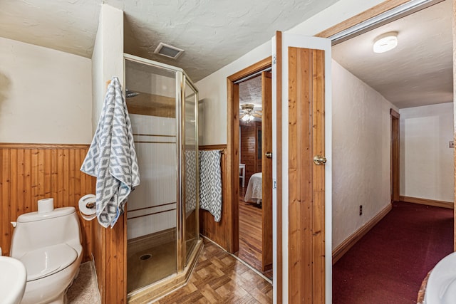 8661 Elm Valley Rd, Union Pier, MI 49129 - full bath featuring a shower stall, toilet, wooden walls, wainscoting, and ensuite bath