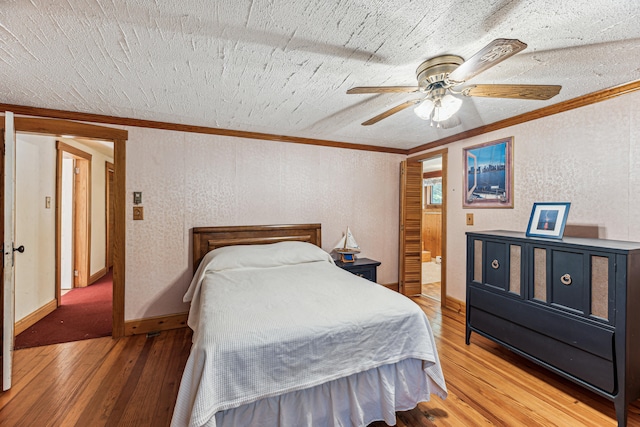 8661 Elm Valley Rd, Union Pier, MI 49129 - bedroom with crown molding, wood-type flooring, baseboards, a textured wall, and ceiling fan
