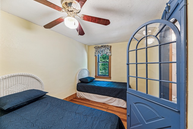 8661 Elm Valley Rd, Union Pier, MI 49129 - bedroom featuring wood finished floors, ceiling fan, and baseboards