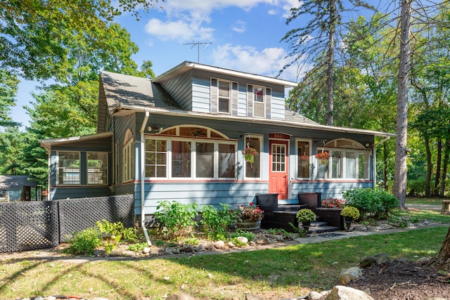 8661 Elm Valley Rd, Union Pier, MI 49129 - view of front of property featuring a sunroom and a front yard
