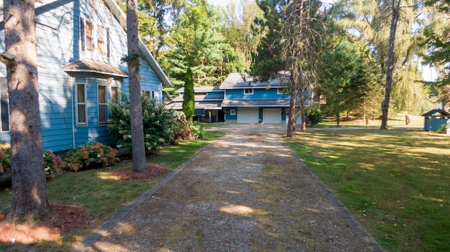 8661 Elm Valley Rd, Union Pier, MI 49129 - view of front facade with driveway and a front yard