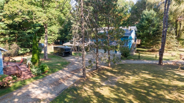 8661 Elm Valley Rd, Union Pier, MI 49129 - view of green lawn with stairway and a wooden deck