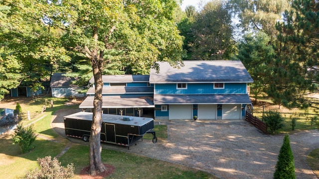 8661 Elm Valley Rd, Union Pier, MI 49129 - view of front of house with driveway, roof with shingles, and view of wooded area
