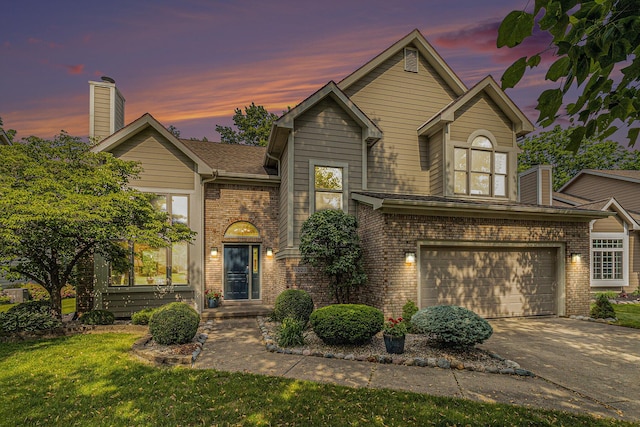 4223 Spring Lake Blvd, Ann Arbor, MI 48108 - view of front of property featuring brick siding, driveway, a garage, and a yard