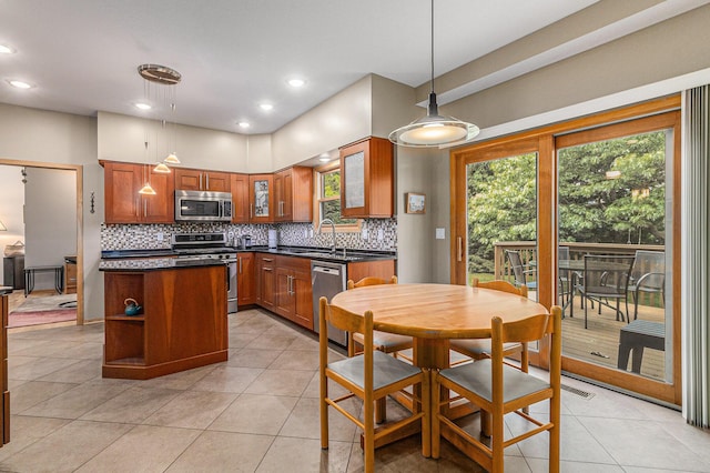 4223 Spring Lake Blvd, Ann Arbor, MI 48108 - kitchen with appliances with stainless steel finishes, backsplash, dark countertops, light tile patterned flooring, and recessed lighting