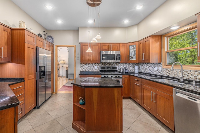 4223 Spring Lake Blvd, Ann Arbor, MI 48108 - kitchen featuring stainless steel appliances, a sink, a center island, brown cabinets, and dark stone countertops