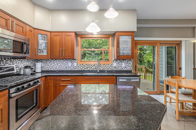 4223 Spring Lake Blvd, Ann Arbor, MI 48108 - kitchen featuring stainless steel appliances, a sink, brown cabinets, backsplash, and dark stone counters