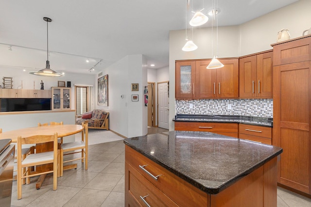 4223 Spring Lake Blvd, Ann Arbor, MI 48108 - kitchen featuring brown cabinetry, backsplash, light tile patterned floors, and open floor plan