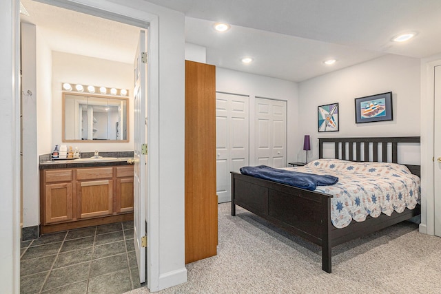 4223 Spring Lake Blvd, Ann Arbor, MI 48108 - bedroom featuring recessed lighting, baseboards, connected bathroom, dark carpet, and a sink