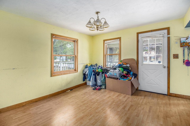 302 Wood St, Hart, MI 49420 - entryway featuring baseboards, a chandelier, and light wood-style floors