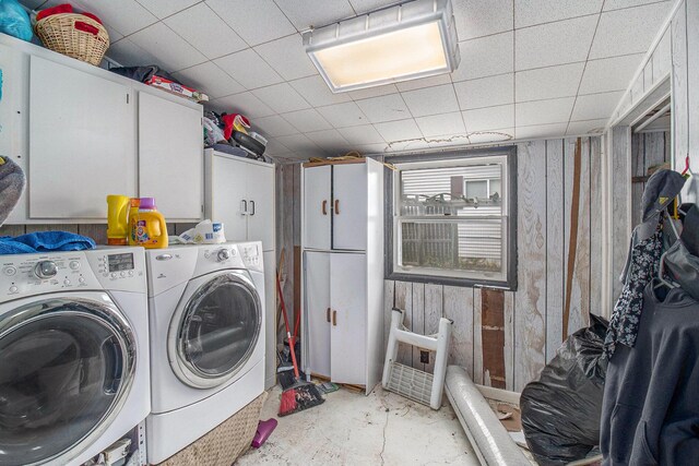 302 Wood St, Hart, MI 49420 - laundry area with cabinet space, separate washer and dryer, and wood walls