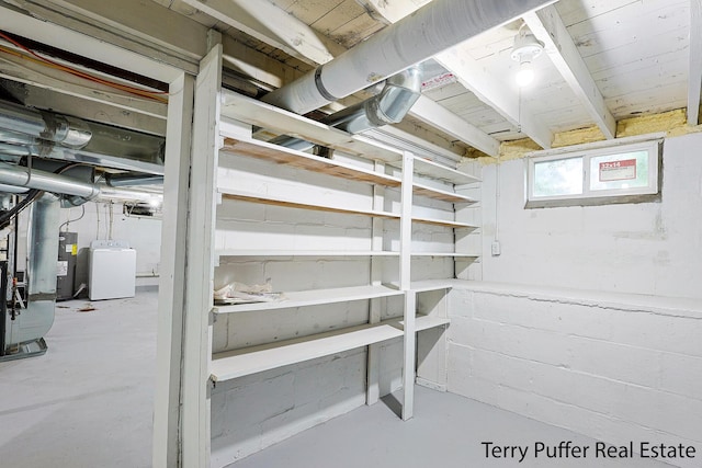987 Oak Ave, Muskegon, MI 49442 - basement featuring washer / dryer, water heater, and heating unit