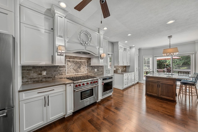 33081 Old Post Rd, Niles, MI 49120 - kitchen with appliances with stainless steel finishes, a ceiling fan, tasteful backsplash, dark wood finished floors, and ornamental molding