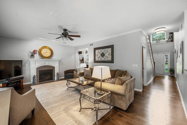 33081 Old Post Rd, Niles, MI 49120 - living area featuring a fireplace, ceiling fan, dark wood-style floors, baseboards, and ornamental molding