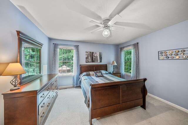 33081 Old Post Rd, Niles, MI 49120 - bedroom featuring light colored carpet, baseboards, multiple windows, and ceiling fan