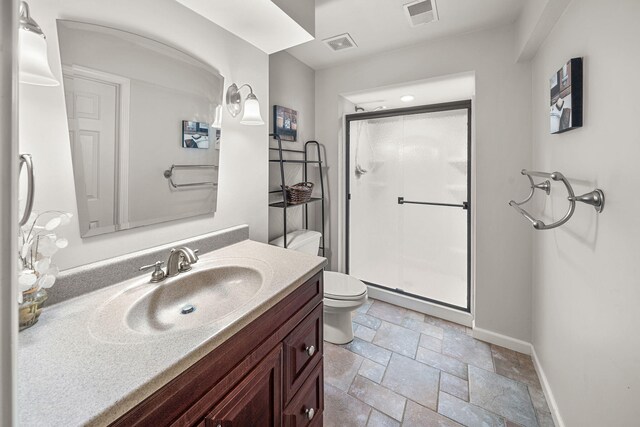 33081 Old Post Rd, Niles, MI 49120 - bathroom with toilet, stone tile flooring, baseboards, vanity, and a shower stall