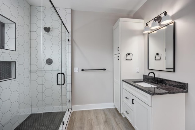 0 Shagawa Trl, Lowell, MI 49331 - bathroom featuring vanity, a stall shower, wood finished floors, and baseboards