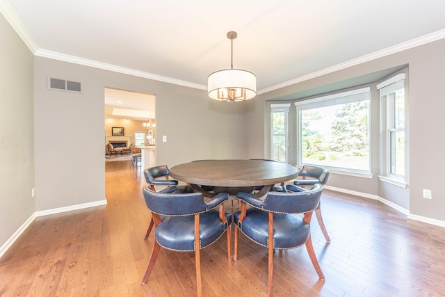 6240 Vineyard Ave, Ann Arbor, MI 48108 - dining room featuring crown molding, a chandelier, baseboards, and wood finished floors
