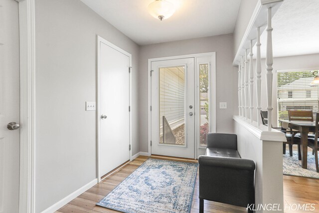 926 N Sandalwood Cir, Muskegon, MI 49441 - foyer with light wood-style floors and baseboards