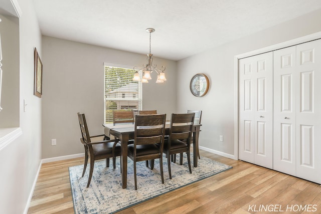926 N Sandalwood Cir, Muskegon, MI 49441 - dining room with a chandelier, light wood finished floors, and baseboards