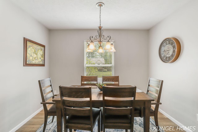 926 N Sandalwood Cir, Muskegon, MI 49441 - dining room featuring a chandelier, light wood-type flooring, and baseboards