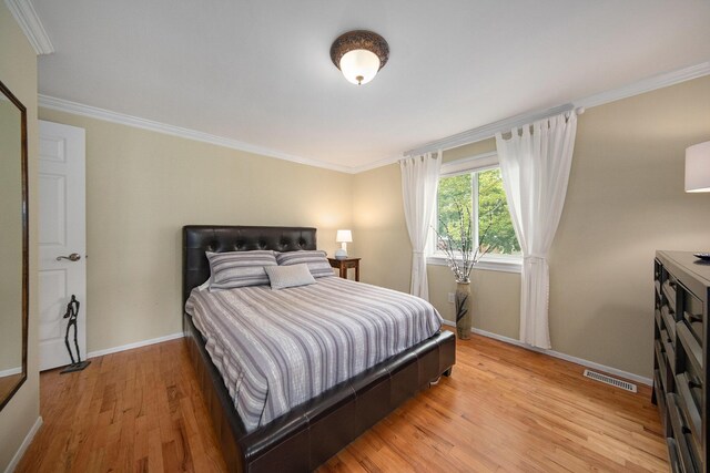 489 Old Creek Ct, Saline, MI 48176 - bedroom featuring baseboards, light wood-style floors, and ornamental molding