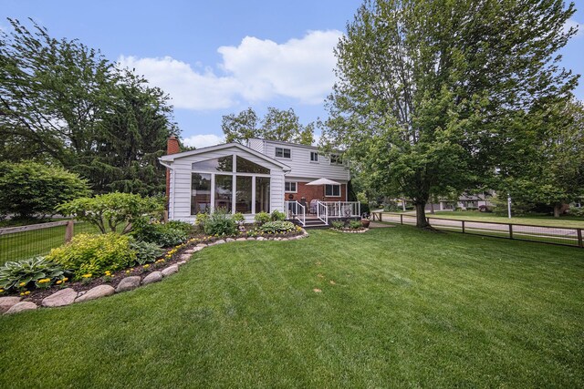489 Old Creek Ct, Saline, MI 48176 - rear view of house featuring a chimney and a deck