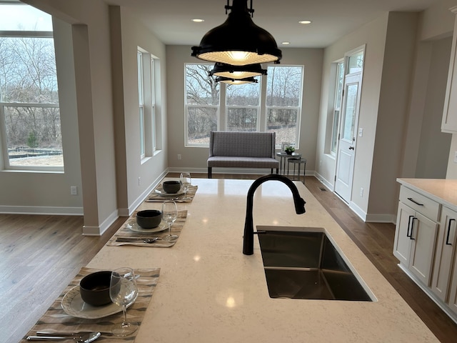 4846 W Burton Ln Unit 22, Saline, MI 48176 - kitchen with a sink, light stone counters, healthy amount of natural light, baseboards, and recessed lighting