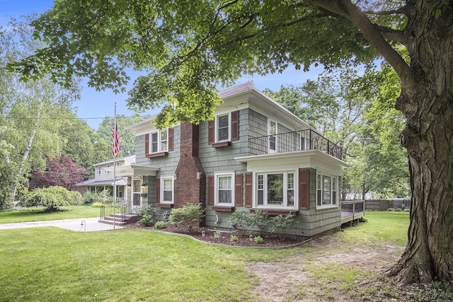 3544 Briggs Blvd NE, Grand Rapids, MI 49525 - view of front of home featuring a balcony and a front lawn