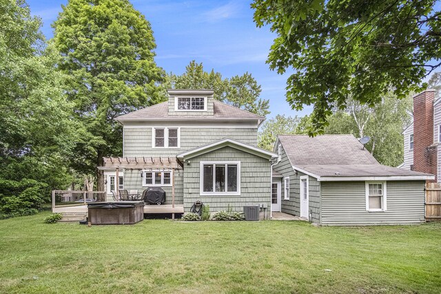 3544 Briggs Blvd NE, Grand Rapids, MI 49525 - back of property featuring a hot tub, a pergola, central AC unit, and a yard