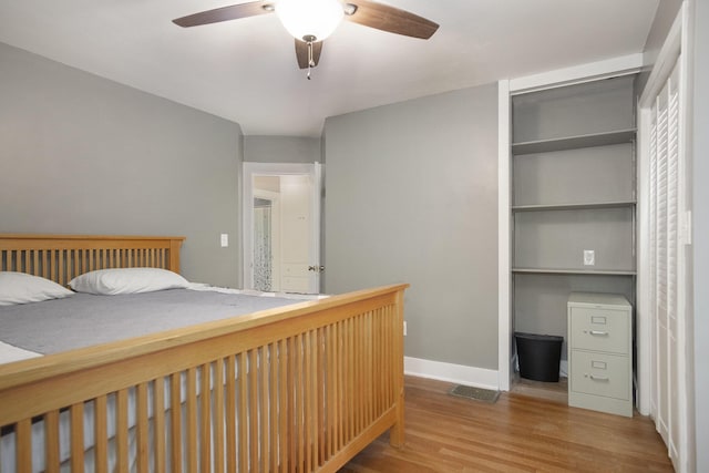 3544 Briggs Blvd NE, Grand Rapids, MI 49525 - bedroom with wood finished floors, a closet, baseboards, and a ceiling fan