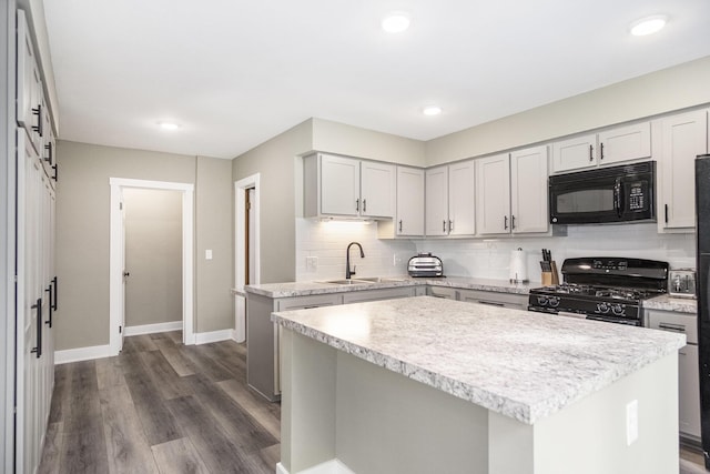 3544 Briggs Blvd NE, Grand Rapids, MI 49525 - kitchen featuring black appliances, a sink, light countertops, a center island, and recessed lighting