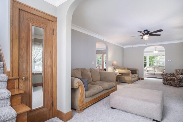 3544 Briggs Blvd NE, Grand Rapids, MI 49525 - living area with arched walkways, light colored carpet, a ceiling fan, ornamental molding, and baseboards