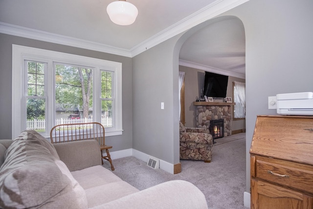 3544 Briggs Blvd NE, Grand Rapids, MI 49525 - living area featuring crown molding, arched walkways, a stone fireplace, light colored carpet, and baseboards