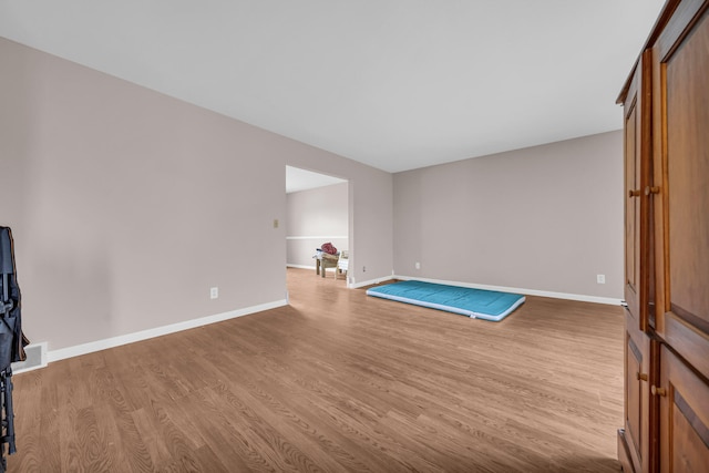 2045 E Baldwin Rd, Grand Blanc, MI 48439 - unfurnished living room with wood finished floors and baseboards