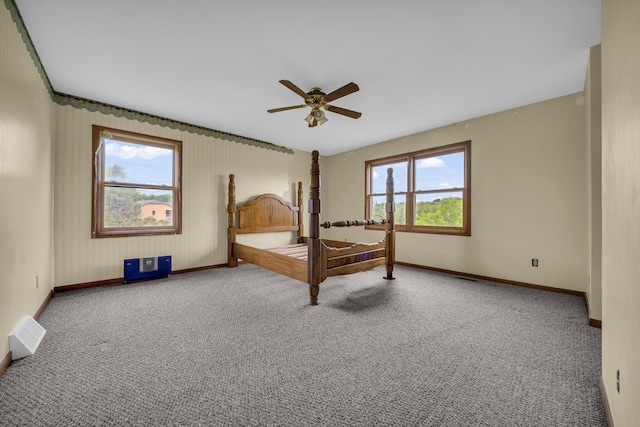 2045 E Baldwin Rd, Grand Blanc, MI 48439 - unfurnished bedroom featuring baseboards, multiple windows, and carpet flooring