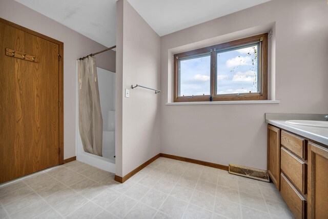 2045 E Baldwin Rd, Grand Blanc, MI 48439 - full bathroom featuring curtained shower, baseboards, and vanity
