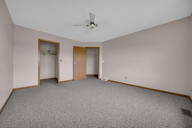 2045 E Baldwin Rd, Grand Blanc, MI 48439 - unfurnished bedroom with multiple closets, baseboards, light carpet, and ceiling fan