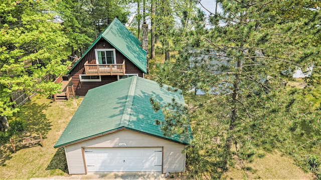1142 Wolf Lake Dr, Baldwin, MI 49304 - view of front of house featuring a garage, a deck, and stairs