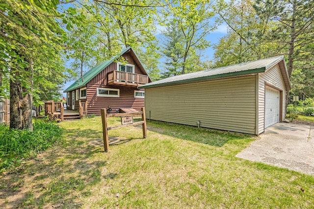 1142 Wolf Lake Dr, Baldwin, MI 49304 - back of house featuring an outbuilding, a lawn, a balcony, and a wooden deck