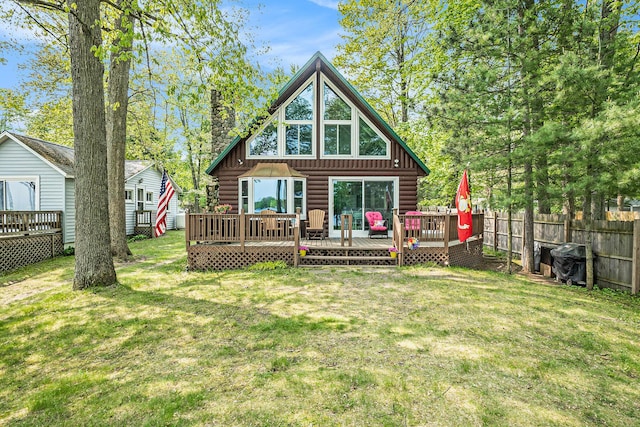 1142 Wolf Lake Dr, Baldwin, MI 49304 - back of property with a chimney, a deck, and log exterior