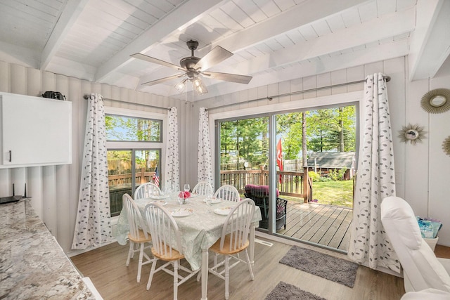 1142 Wolf Lake Dr, Baldwin, MI 49304 - dining space with light wood finished floors, ceiling fan, and beamed ceiling