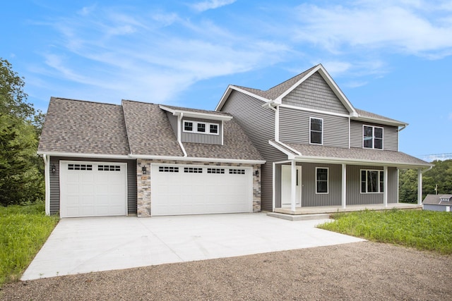 2141 N 35th St, Galesburg, MI 49053 - view of front facade featuring a garage, concrete driveway, a porch, a shingled roof, and stone siding
